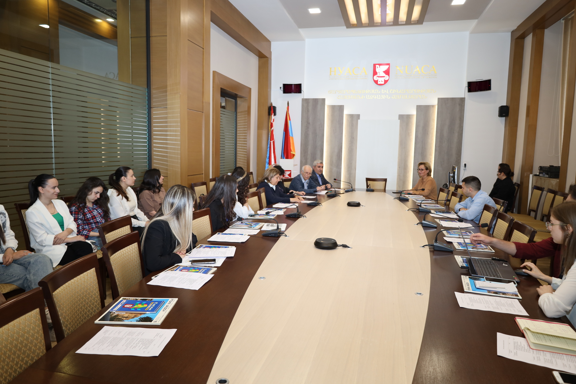 People sitting around an oval table