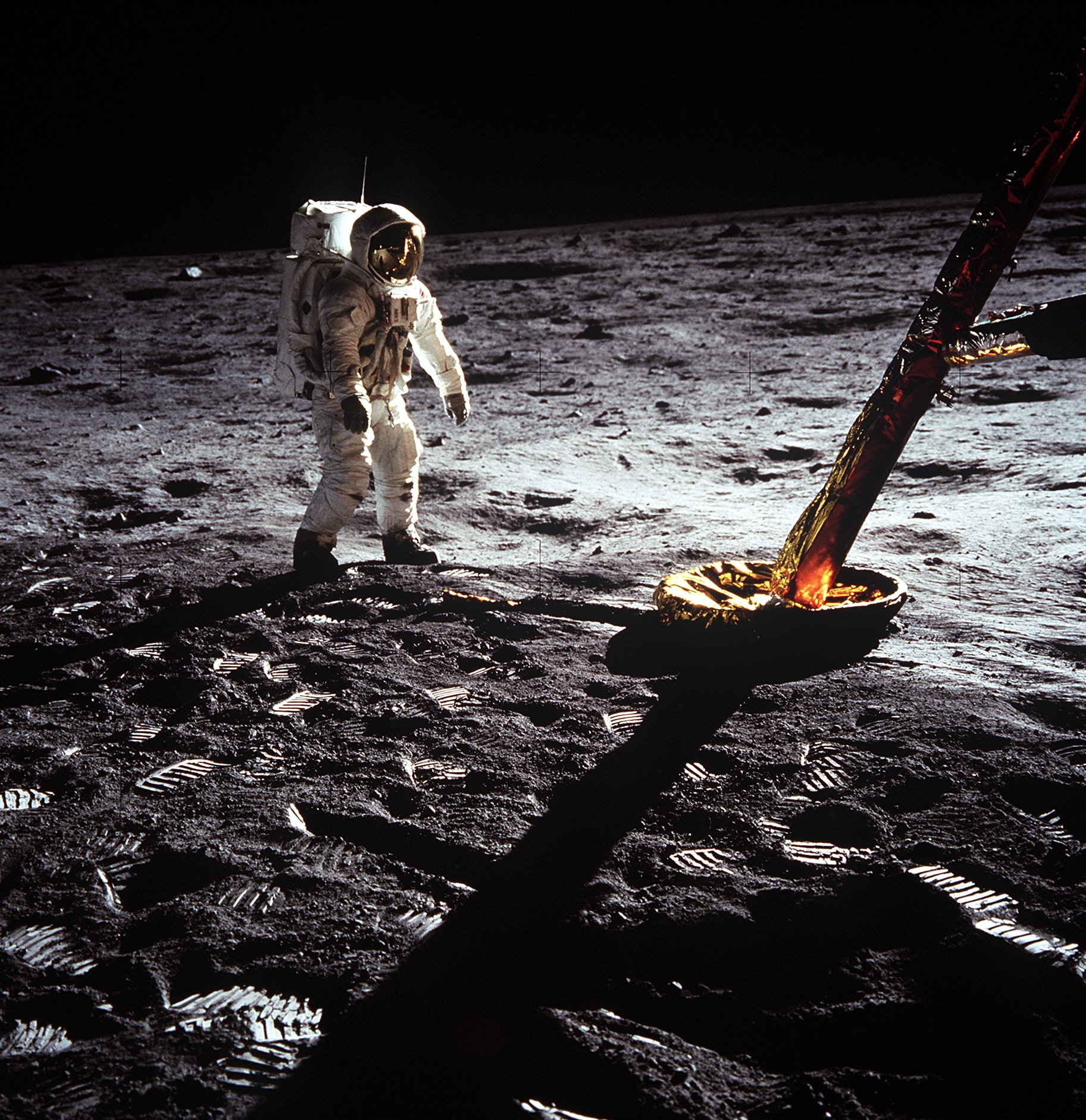 Astronaut in full suit walking on the moon surface near leg of a lunar module