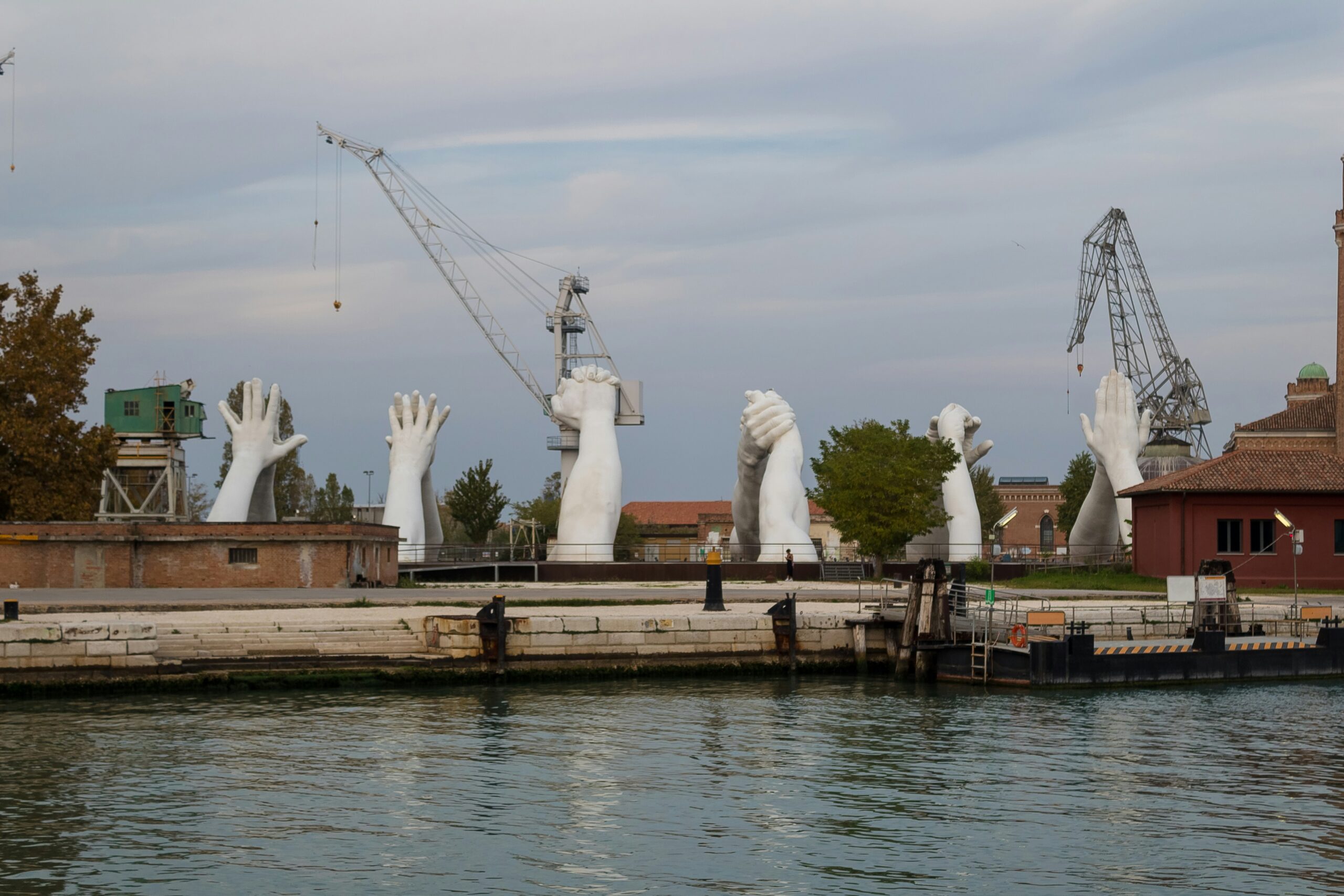 Picture showing Lorenzo Quinn's 'Building Bridges' hand sculptures in Venice's historic shipyard